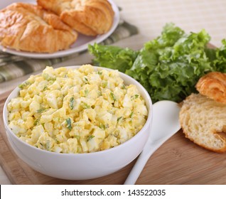 Egg Salad In A Bowl With Lettuce And Croissant Rolls For Making Sandwiches