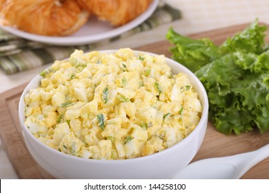 Egg Salad In A Bowl With Lettuce On The Side For Making Sandwiches