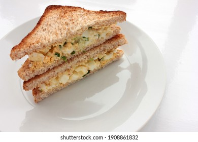 Egg Salad Sandwich With Whole Wheat Toasted Bread On Plate On White Background. Healthy Snack Concept. Top View, Copy Space, Selective Focus