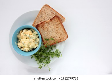 Egg Salad Sandwich With Whole Wheat Toasted Bread And Microgreens On Plate On White Background. Healthy Food Concept. Top View, Selective Focus