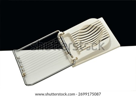 The egg slicer kitchen appliance is designed for quick and even slicing of peeled boiled eggs.