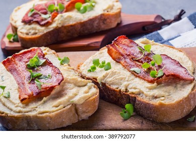 Egg spread grilled bacon bread young basil leaves and herb decoration. 