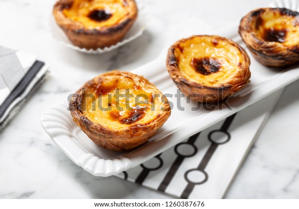 Egg tart on tray, traditional portuguese\
dessert, pastel de nata, custard\
tarts