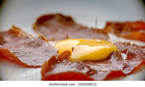 The Egg Is Thrown Into The Turkish Pastrami In The Hot Pan. 