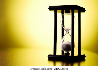 Egg Timer Or Hourglass On A Graduated Yellow Background With Copyspace In A Conceptual Image Of Passing Time And Time Management