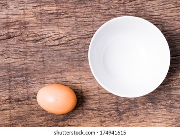 Egg And White Bowl On Wooden Table Top