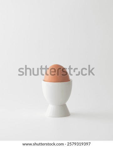 Egg in an white eggcup on a white background.