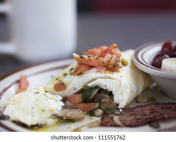 Egg White Omelette With Tomatoes, Spinach, Mushrooms And Turkey Bacon.