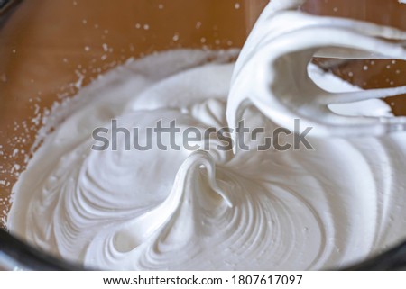 Egg whites beaten to a frothy stage. Whipped egg whites for meringue.