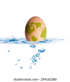 Egg with world map drop in blue water with shallow depth of field