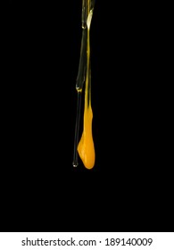 Egg Yolk Dripping On Black Background.