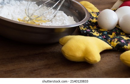 Egg Yolks With Refined Flour Inside Metal Bowl With A Whisk Inside The Bowl Dirty With The Flour And Fabric Chicken Part With Eggs On Top On The Right Side Of The Photo