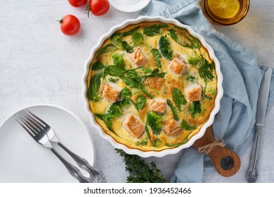 Egg-based Frittata, Omelette With Salmon, Broccoli And Spinach. Italian Dish, Crustless Quiche With Eggs, Fish And Vegetables. Mediterranean Ketogenic Healthy Diet. Top View