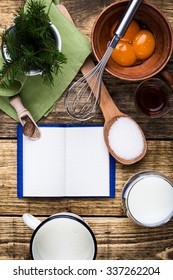 Eggnog  Ingredients On Rustic Wooden Table With Copy Space Viewed From Above.  Egg Milk Punch With Raw Egg Yolks, Milk, Cream, Sugar,  Bourbon, Ground Nutmeg, Cook Book For Recipes