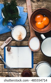 Eggnog  Ingredients On Rustic Wooden Table With Copy Space Viewed From Above.  Egg Milk Punch With Raw Egg Yolks, Milk, Cream, Sugar,  Bourbon, Ground Nutmeg, Cook Book For Recipes