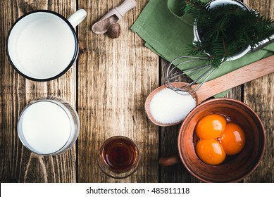 Eggnog  Ingredients On Rustic Wooden Table Viewed From Above.  Egg Milk Punch With Raw Egg Yolks, Milk, Cream, Sugar,  Bourbon, Ground Nutmeg