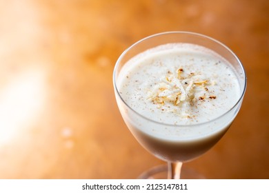 Eggnog Rum Cocktail With Toasted Coconut And Nutmeg