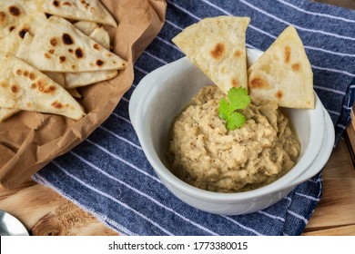 Eggplant caviar with homemade pita bread on wooden background with napkin
