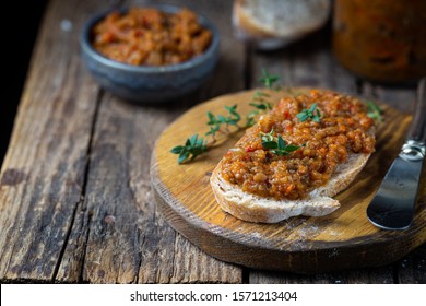 Eggplant dip with bread. Sandwich with eggplant caviar on wooden background