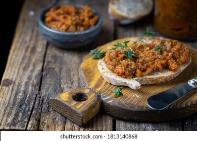 Eggplant dip with bread. Sandwich with eggplant caviar on wooden background