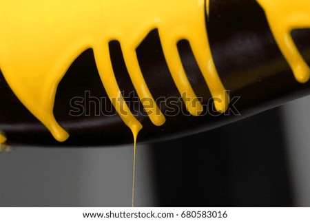 Eggplant with pouring yellow paint background, macro closeup.Texture