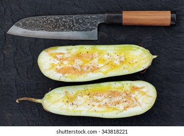 Eggplant prepared for grilling and handmade knife