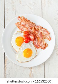Eggs and bacon with tomato for breakfast