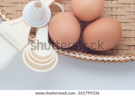 Eggs and baking tools on white table top background