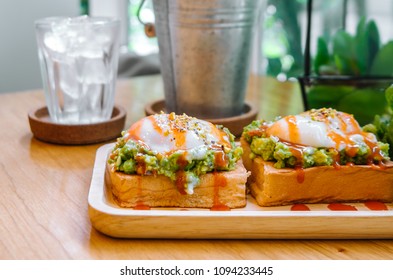 Eggs Benedict With Avocado And Hot Sauce