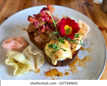 Eggs Benedict On Toast With Fried Chicken Strips, Garnished With Flowers