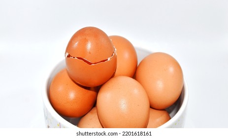 Eggs In A Bowl With One Cracked Egg