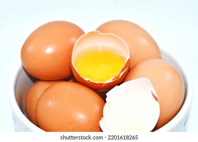 Eggs In A Bowl With One Cracked Egg