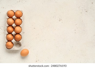 Eggs in carton box on light grunge background - Powered by Shutterstock