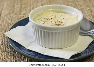 Eggs En Cocotte, An Individual Whole Egg Baked In A Ramekin With Creme Fraiche And Seasoned With Salt And Pepper, Selectively Focused To Accentuate The Surface Of The Food 