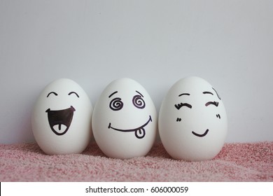 Eggs are funny with faces. Concept of laughter. Photo for your design on a white background