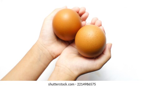 Eggs In The Hands Of The Child, Isolated On White Background. Fresh Cooking Ingredients For Breakfast.