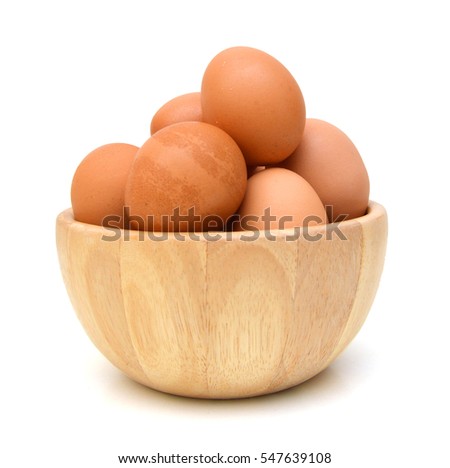Eggs isolated in wooden bowl on white background