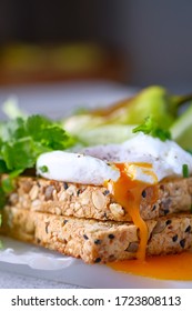 Eggs On Wholemeal Toast With Runny Egg Yolk.