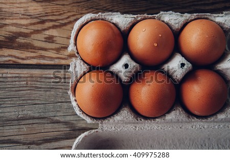 eggs in paper on wooden background