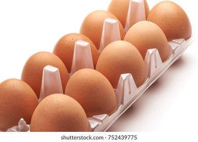 Eggs in plastic box, isolated on white background.