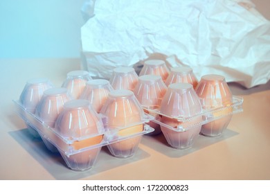 Eggs in plastic box. On the background there is a paper bag