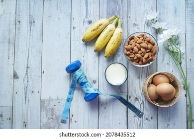 Eggs In A Plastic Container, Milk And Almond Nut In Table 