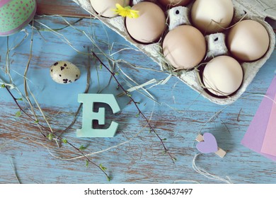 Eggs, quail, easter decor on a blue wooden table, top view