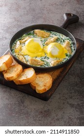 Eggs Sardou Is A Louisiana Creole Cuisine Dish Made With Poached Eggs, Artichoke Bottoms, Creamed Spinach And Hollandaise Sauce Close Up In The Plate On The Table. Vertical
