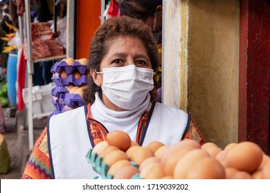 Eggs Seller In Respiratory Mask In The Market During Coronavirus Pandemic In Cusco, Peru In Latin South America. Epidemic Of Coronavirus Covid-19