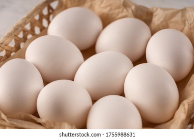 Eggs In A Square Wicker Basket On Parchment Paper. Close Up.