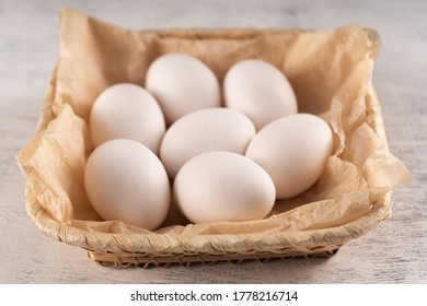 Eggs In A Square Wicker Basket On Parchment Paper. Close Up.