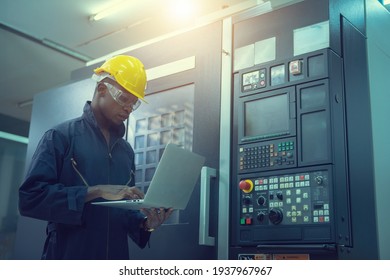 The egineer in the industial working with computer control the machine