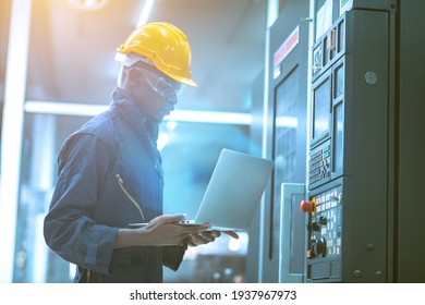 The egineer in the industial working with computer control the machine