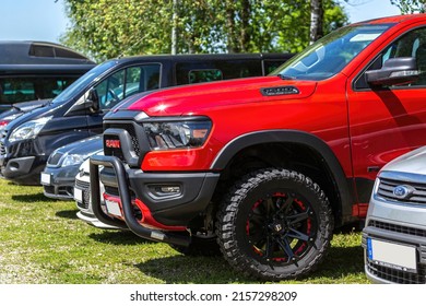 Eging am See, bavaria, germany, 14. may 2022: A red dodge RAM 1500 rebel pick-up parking on a meadow between other cars